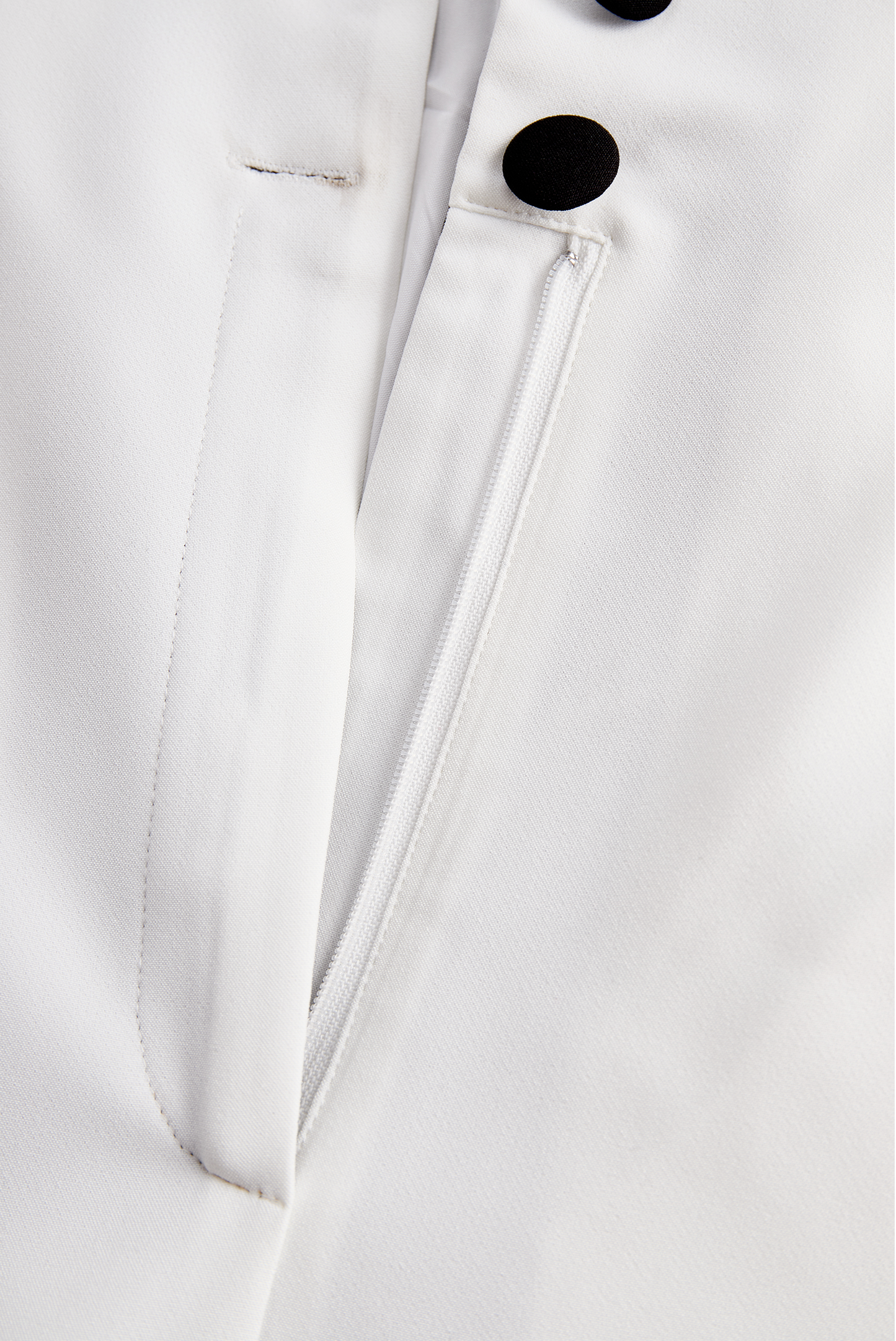 Sleek White Jumpsuit With Dual Button Detail And Black Lapel